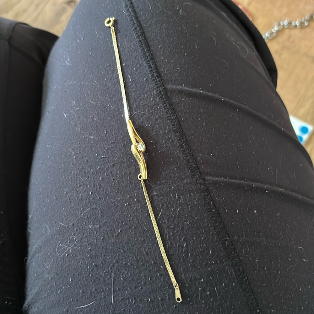 Gold tone bracelet with diamond center